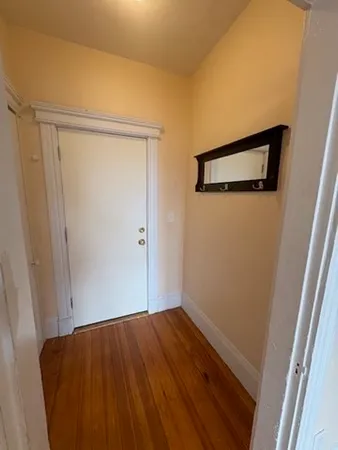 a view of a room with wooden floor