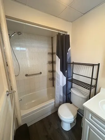 a bathroom with a toilet and a shower