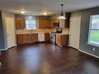 a kitchen with stainless steel appliances a refrigerator sink and microwave
