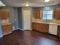 a kitchen with stainless steel appliances granite countertop a sink a stove a refrigerator and cabinets