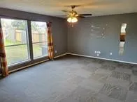 an empty room with windows and outdoor view