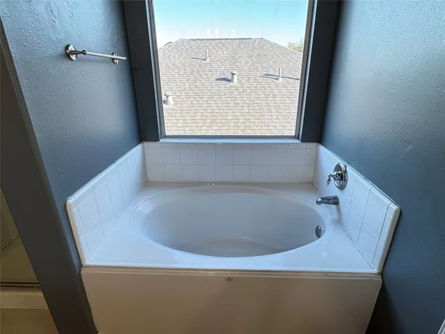 a bathroom with a shower and a mirror