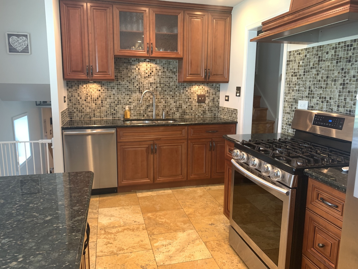 7621 Sawyer Road Darien, IL 60561 - Photo 12 of 28 a kitchen with stainless steel appliances granite countertop a stove a sink and a microwave