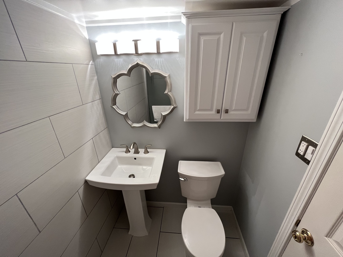 7621 Sawyer Road Darien, IL 60561 - Photo 17 of 28 a bathroom with a toilet sink and mirror