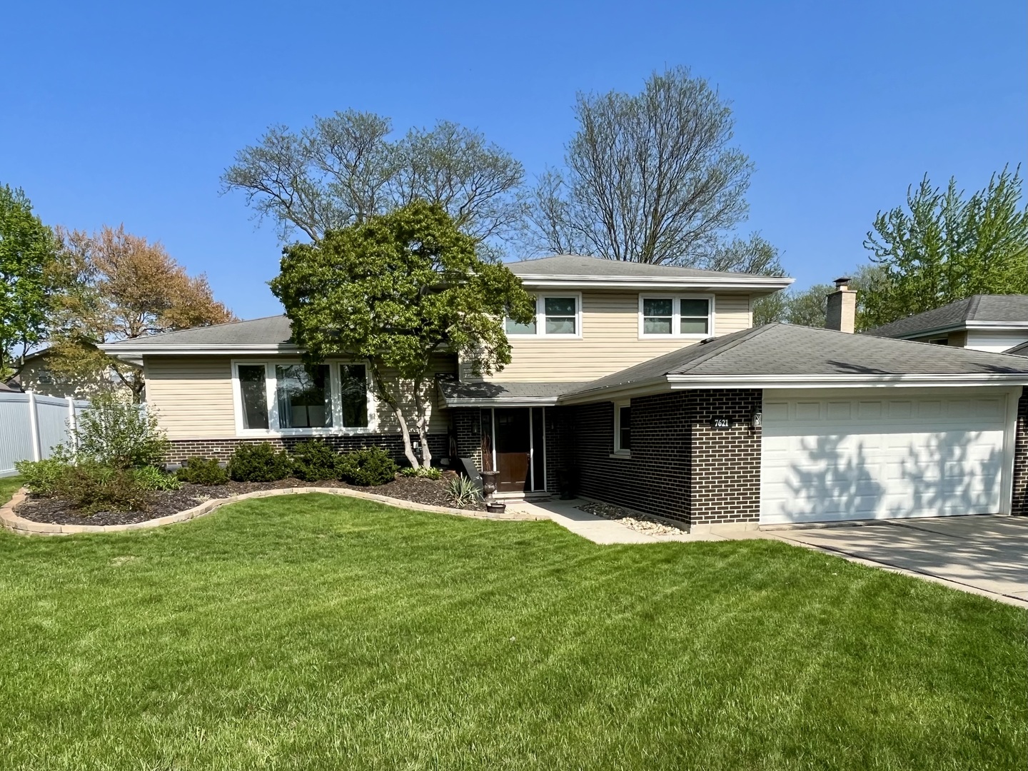 7621 Sawyer Road Darien, IL 60561 - Photo 2 of 28 a front view of a house with a yard