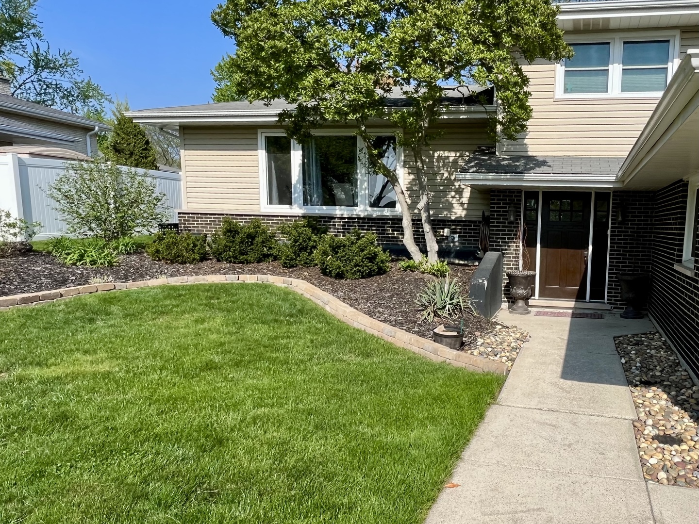 7621 Sawyer Road Darien, IL 60561 - Photo 3 of 28 a front view of a house with garden and porch