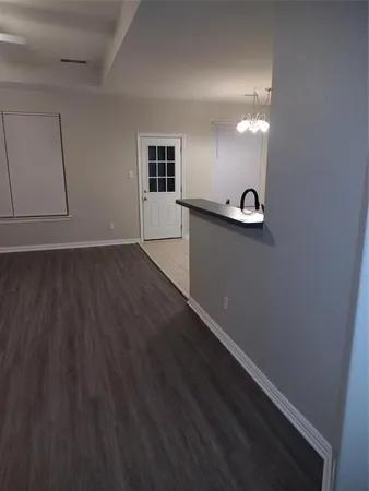 a view of a room with wooden floor and windows