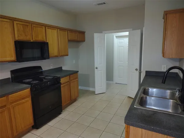 a kitchen with a sink and a stove top oven