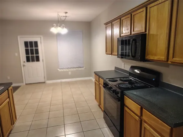 a kitchen with a stove and a cabinet