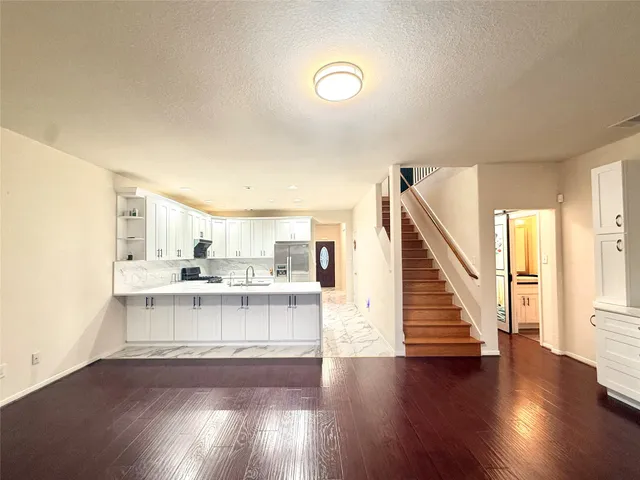 a view of kitchen with wooden floor and electronic appliances