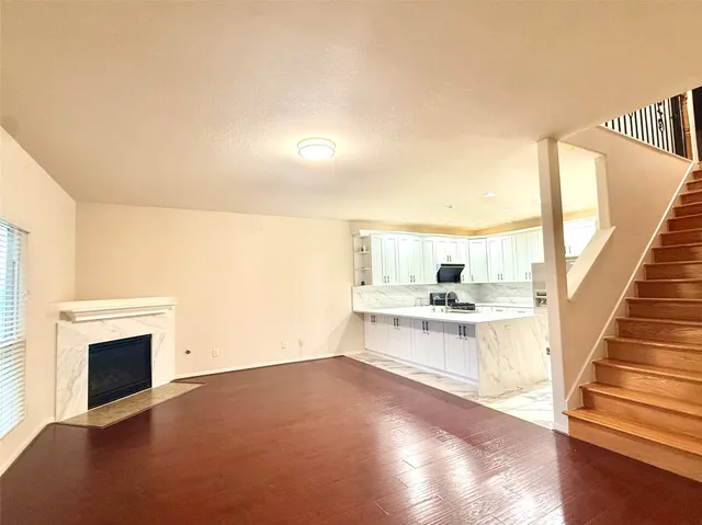 a view of open kitchen with granite countertop cabinets and outdoor view