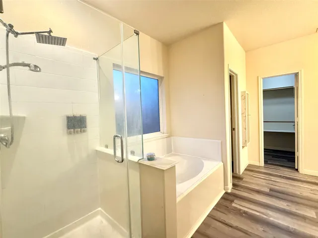 a bathroom with a bathtub and a shower