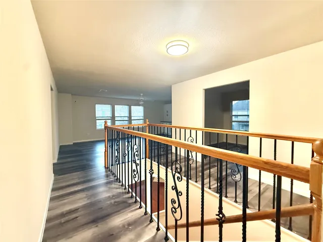 a view of hallway with wooden floor