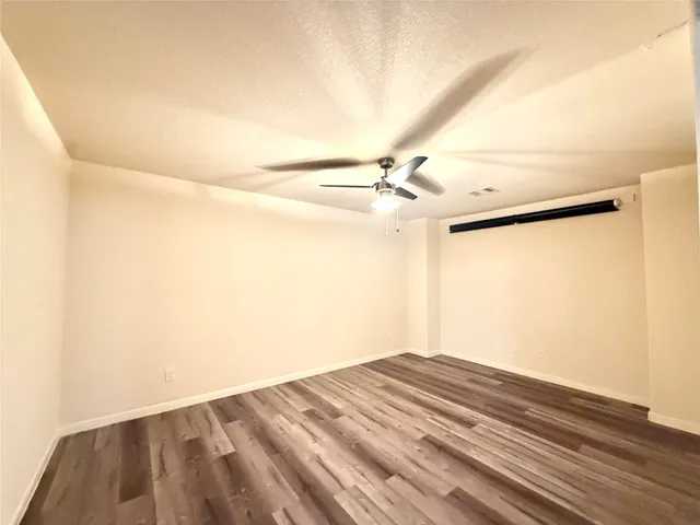 a view of a room with a ceiling fan