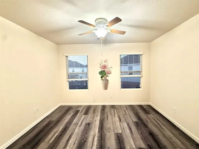 a view of a ceiling fan and wooden floor