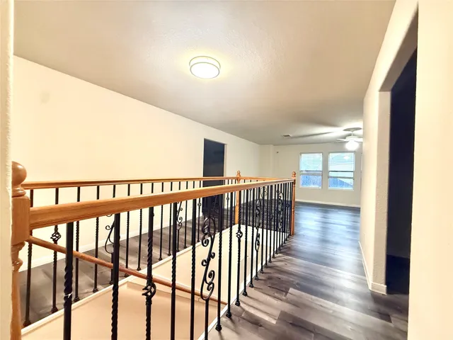 a view of hallway with wooden floor