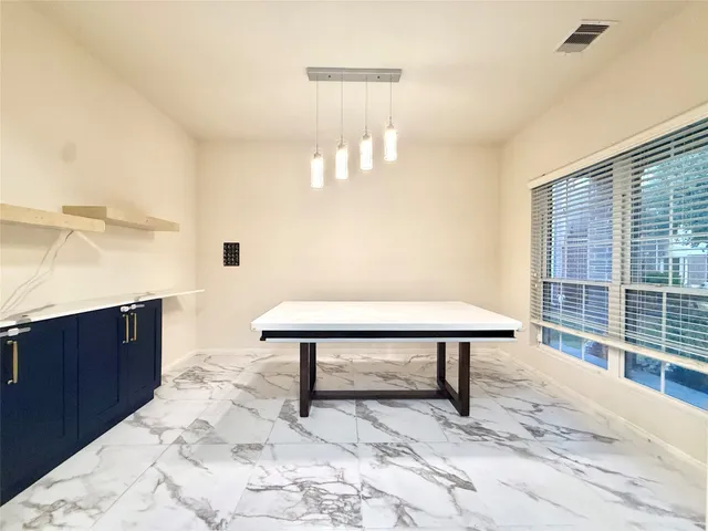 a view of a bedroom with furniture and window