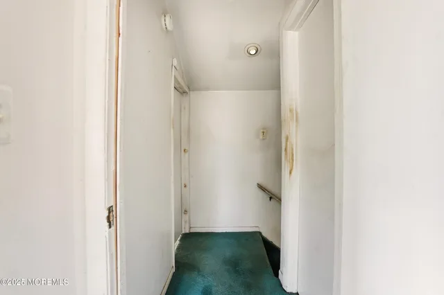 a view of a hallway with white walls