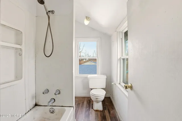 a bathroom with a toilet and a shower