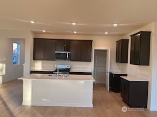37425 30th Place South Federal Way, WA 98003 - Photo 3 of 6 a kitchen with stainless steel appliances kitchen island granite countertop a stove and a sink