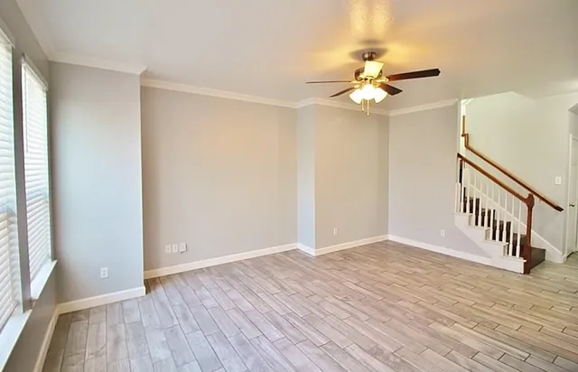 wooden floor in an empty room with a window