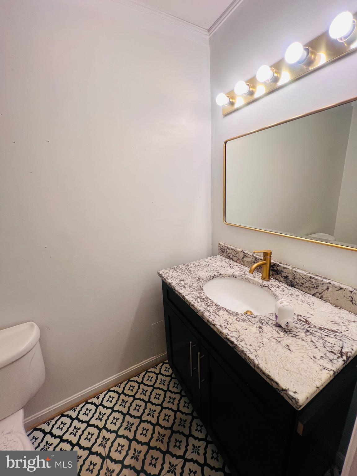 15513 Bealle Hill Road Accokeek, MD 20607 - Photo 19 of 21 a bathroom with a granite countertop sink and a toilet