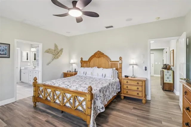 a bedroom with a bed chandelier and a window