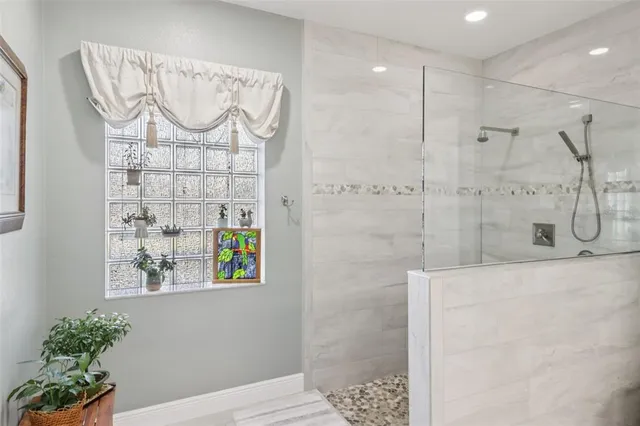 a bathroom with a chandelier and a shower