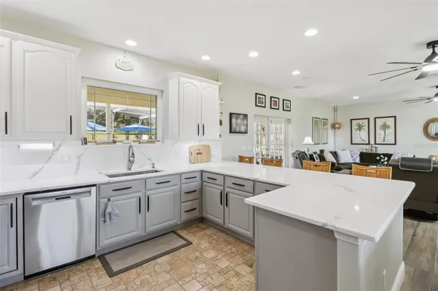 a large kitchen with cabinets a sink and appliances