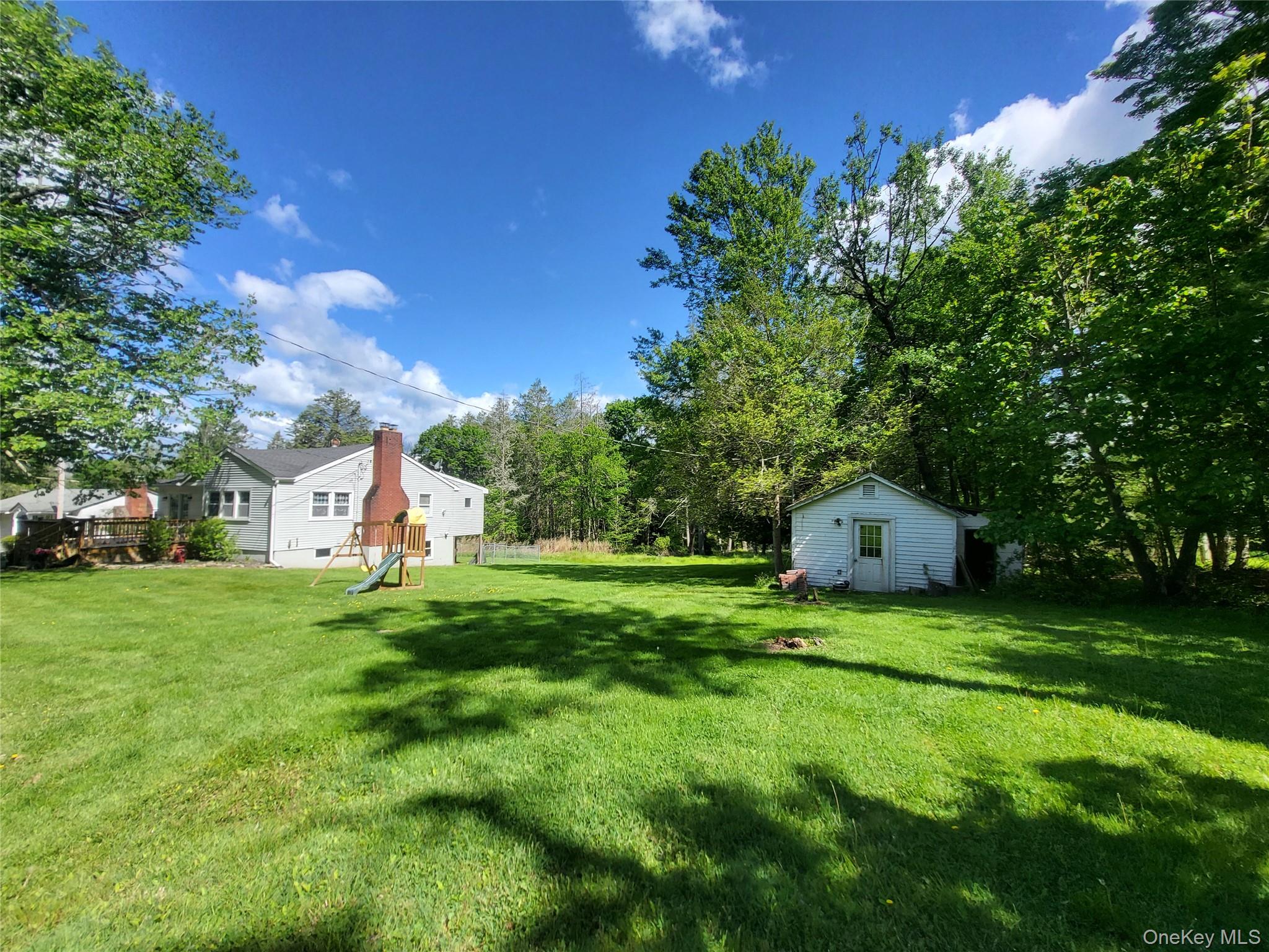 286 Dingle Daisy Road Monticello, NY 12701 - Photo 35 of 35 a view of a tree in front of a house with a big yard