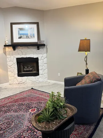 a living room with furniture and a fireplace