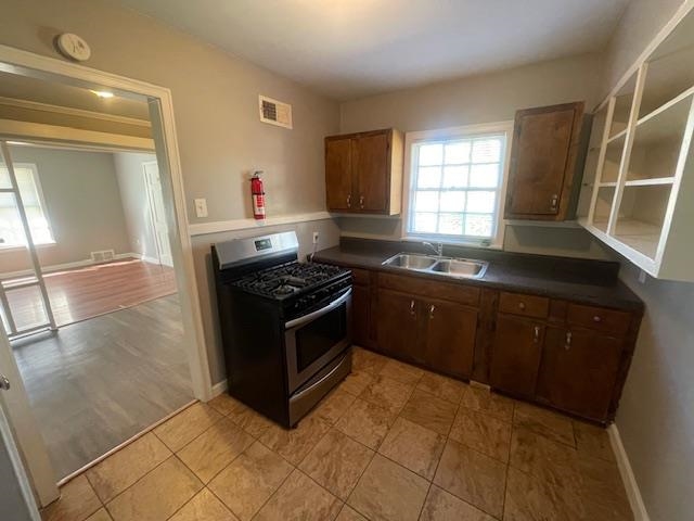802 Waring Road Memphis, TN 38122 - Photo 5 of 12 a kitchen with stainless steel appliances granite countertop a stove a sink and a refrigerator