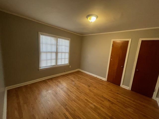 802 Waring Road Memphis, TN 38122 - Photo 9 of 12 an empty room with wooden floor and windows