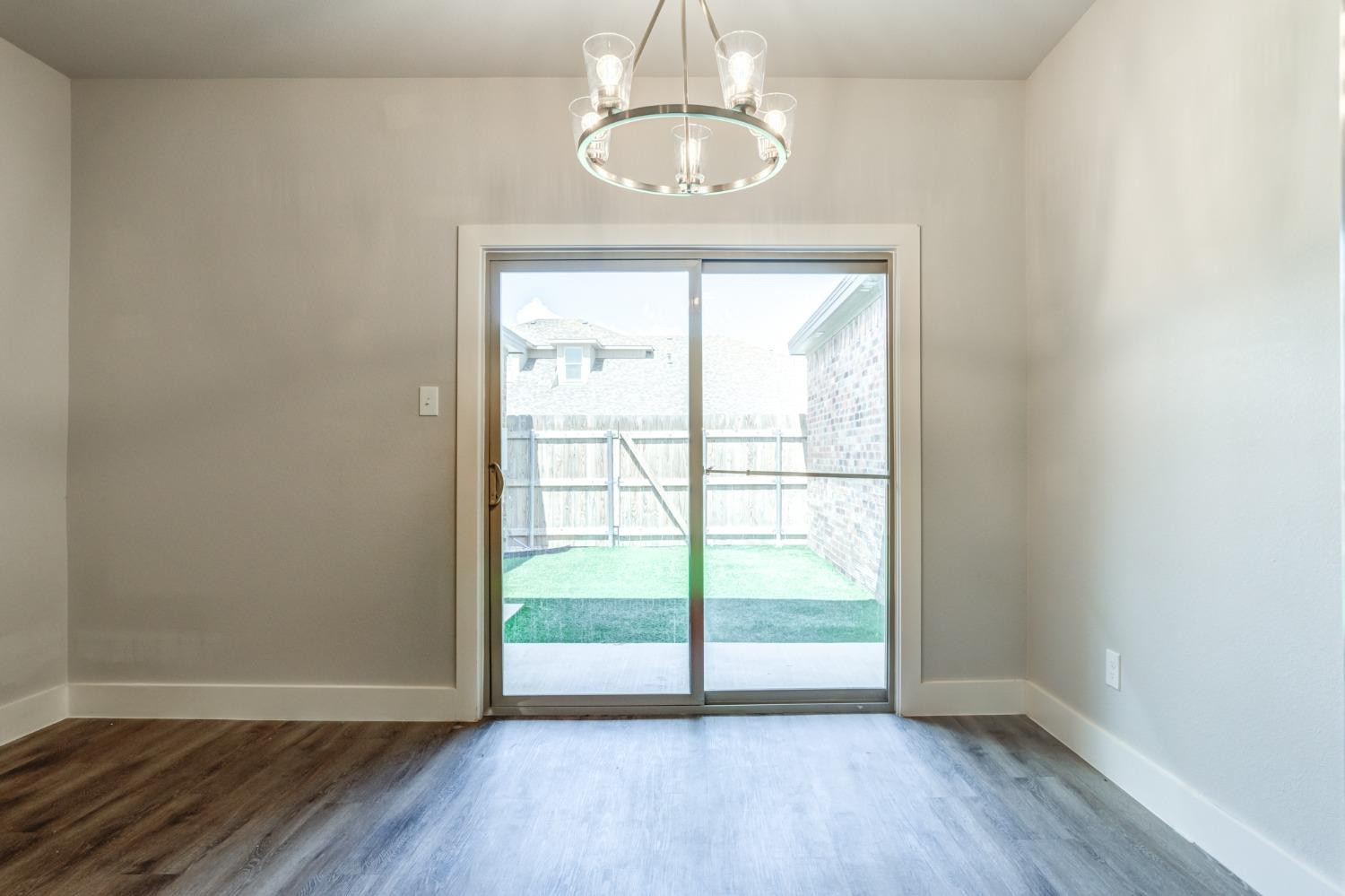 2528 137th Street Lubbock, TX 79423 - Photo 14 of 35 an empty room with wooden floor and windows