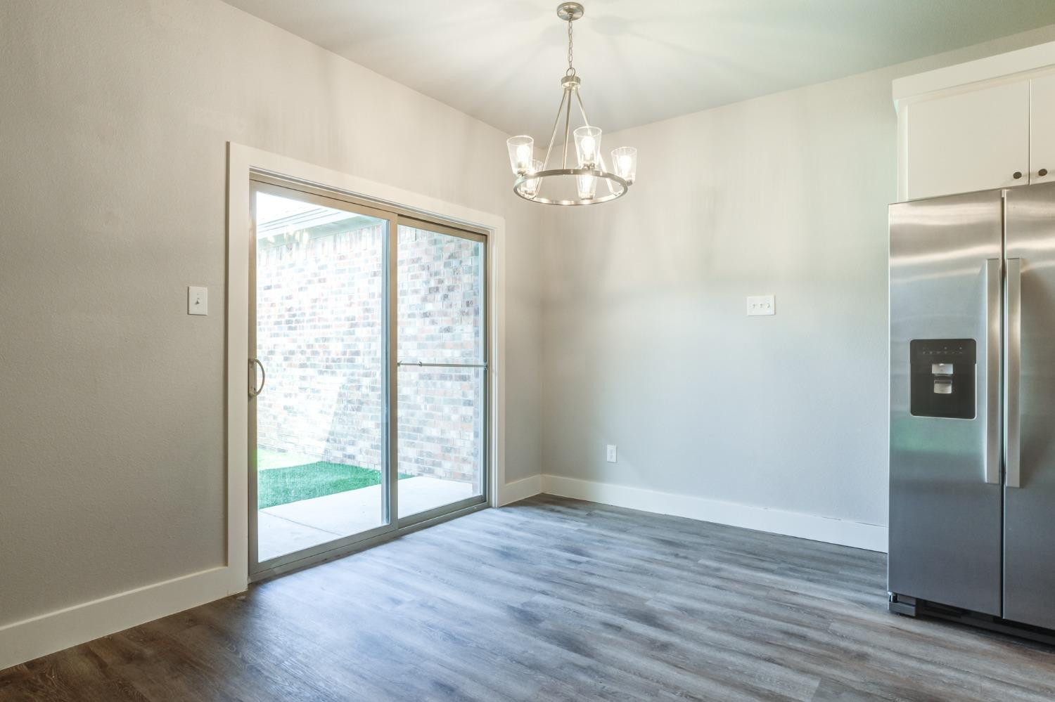2528 137th Street Lubbock, TX 79423 - Photo 15 of 35 a view of a livingroom with wooden floor staircase and a kitchen space