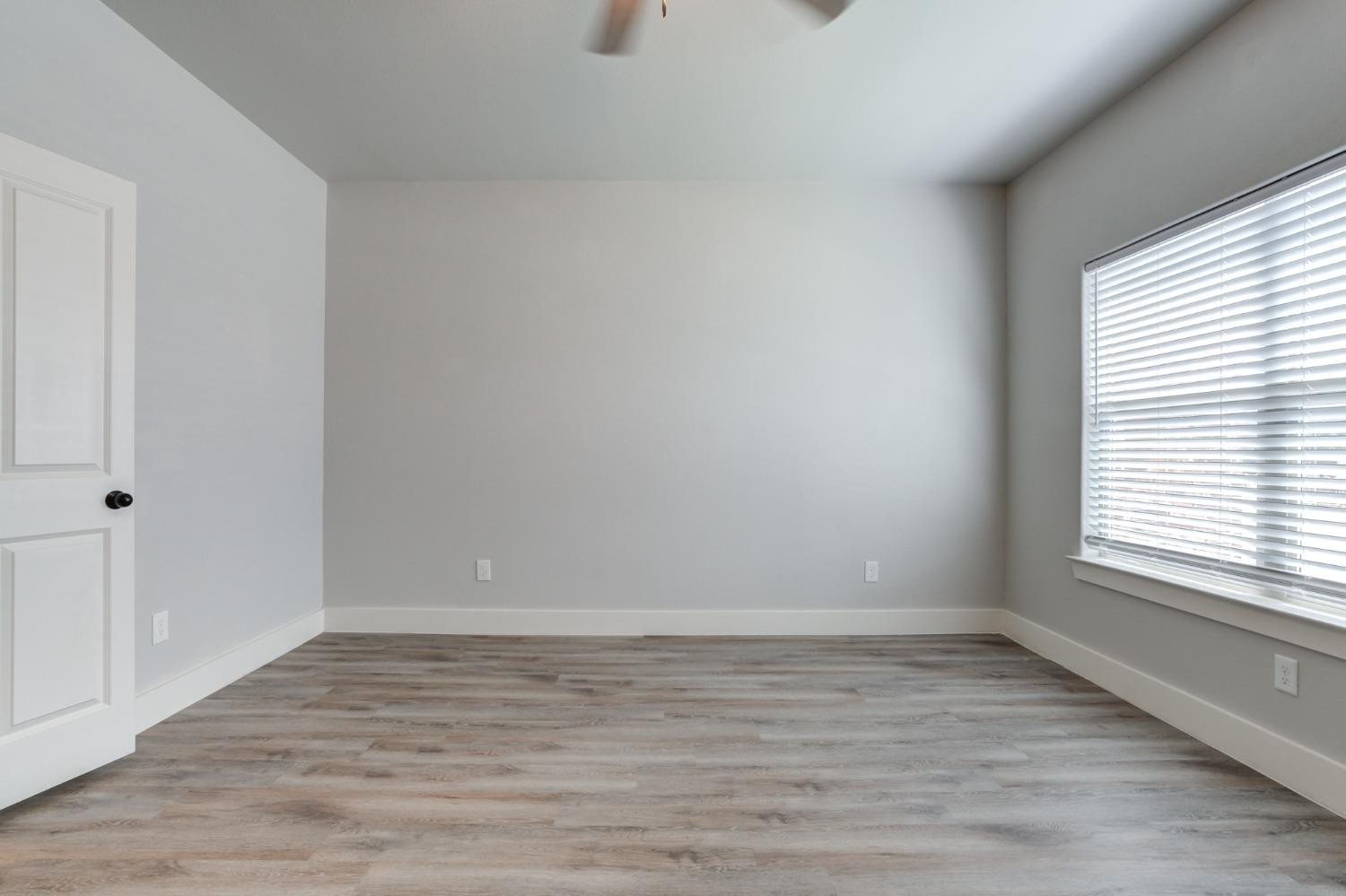 2528 137th Street Lubbock, TX 79423 - Photo 17 of 35 a view of an empty room with wooden floor and a window
