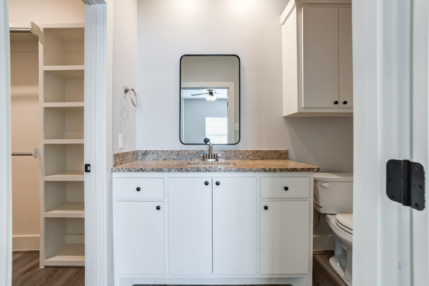 2528 137th Street Lubbock, TX 79423 - Photo 19 of 35 a bathroom with a granite countertop sink and a mirror