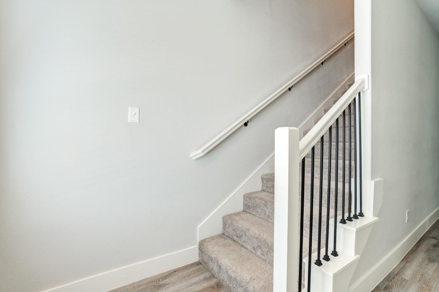 2528 137th Street Lubbock, TX 79423 - Photo 22 of 35 a view of staircase with wooden floor and white walls