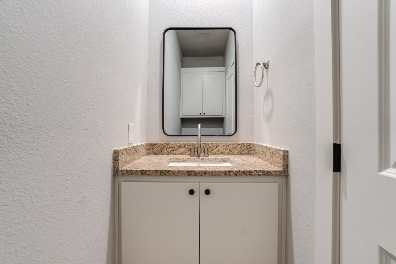 2528 137th Street Lubbock, TX 79423 - Photo 23 of 35 a bathroom with a granite countertop sink and a mirror