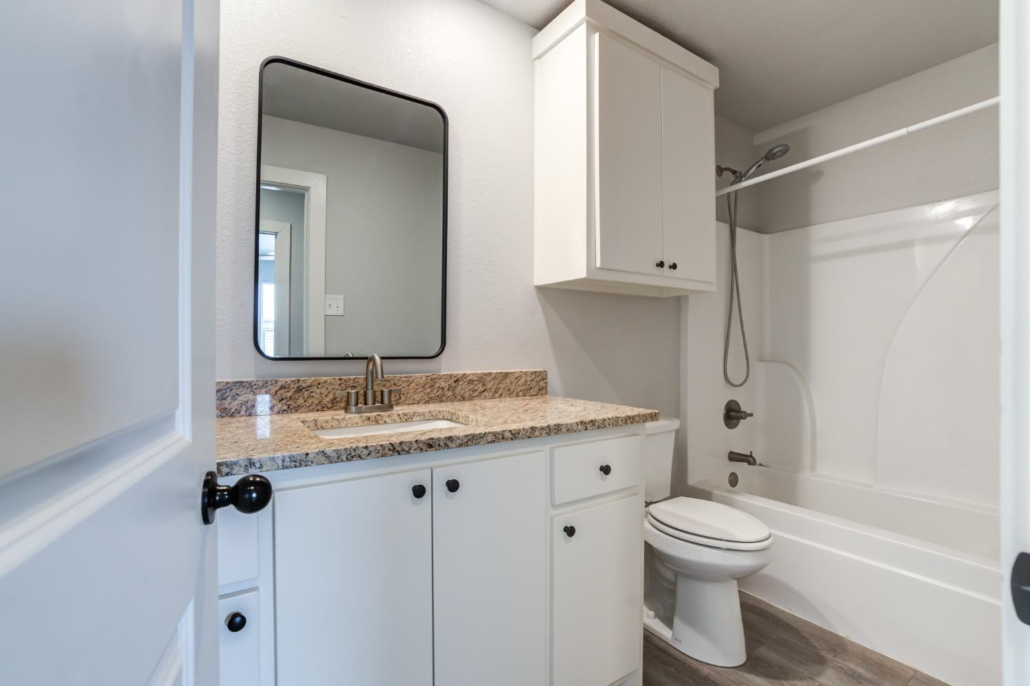 2528 137th Street Lubbock, TX 79423 - Photo 28 of 35 a bathroom with a granite countertop sink toilet and shower