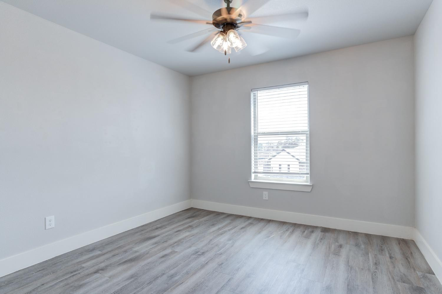 2528 137th Street Lubbock, TX 79423 - Photo 29 of 35 an empty room with a window and a fan