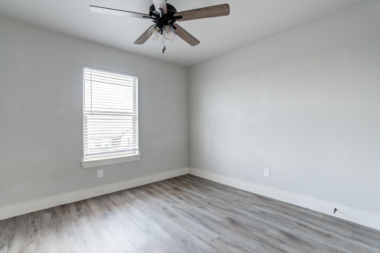 2528 137th Street Lubbock, TX 79423 - Photo 31 of 35 an empty room with a window and a fan