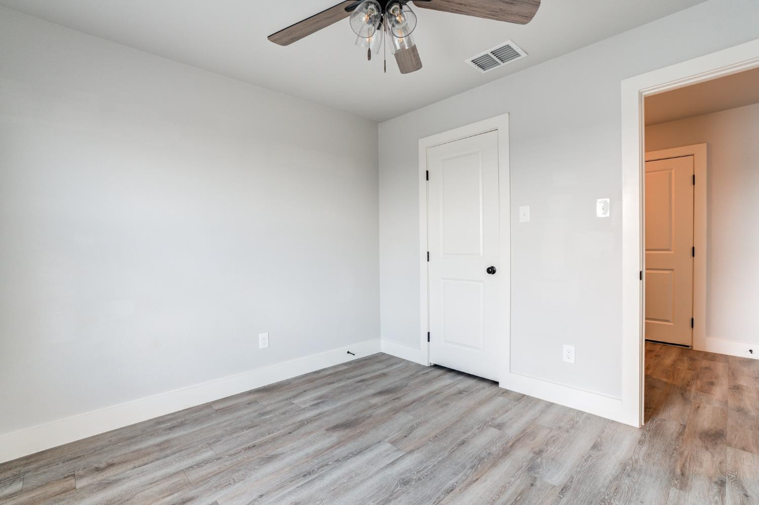 2528 137th Street Lubbock, TX 79423 - Photo 32 of 35 a view of an empty room with wooden floor