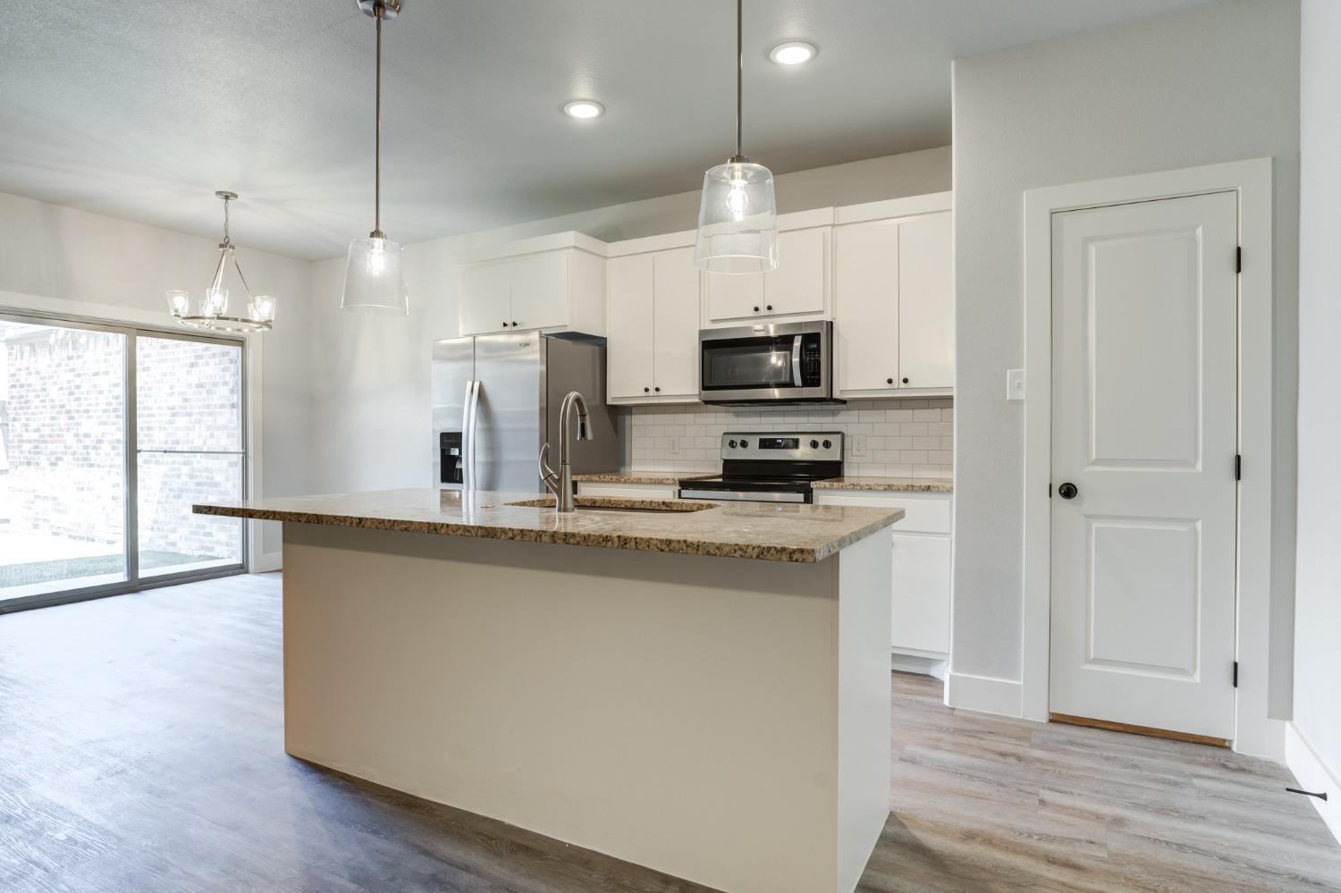 2528 137th Street Lubbock, TX 79423 - Photo 9 of 35 a kitchen with kitchen island a sink stainless steel appliances and cabinets