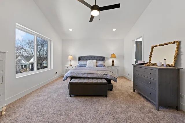 a spacious bedroom with a bed and window