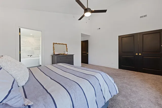 a bedroom with a bed and a mirror