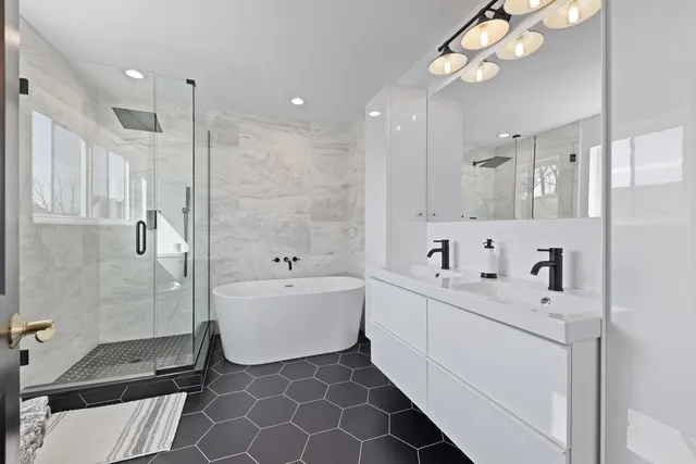 a bathroom with a double vanity sink mirror and shower