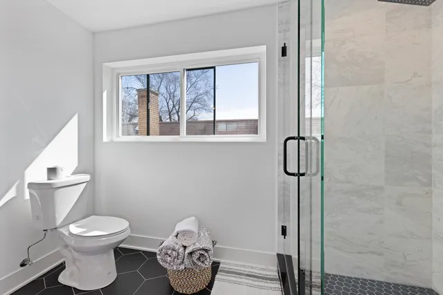 a bathroom with a toilet and a window