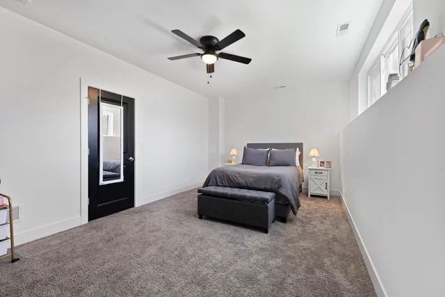 a bedroom with bed and window