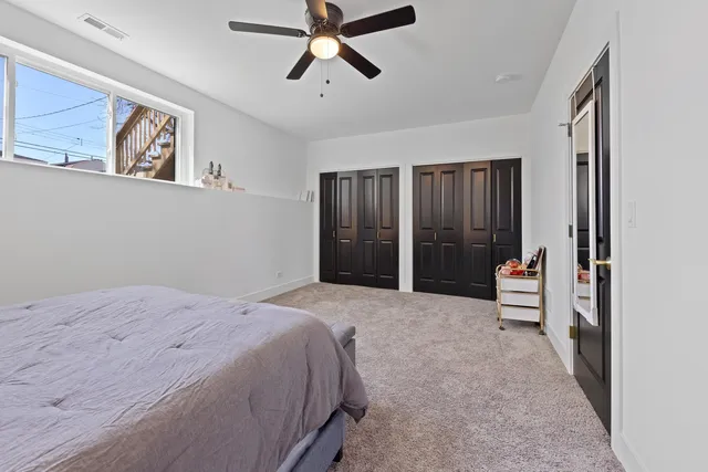 a spacious bedroom with a large bed and a window